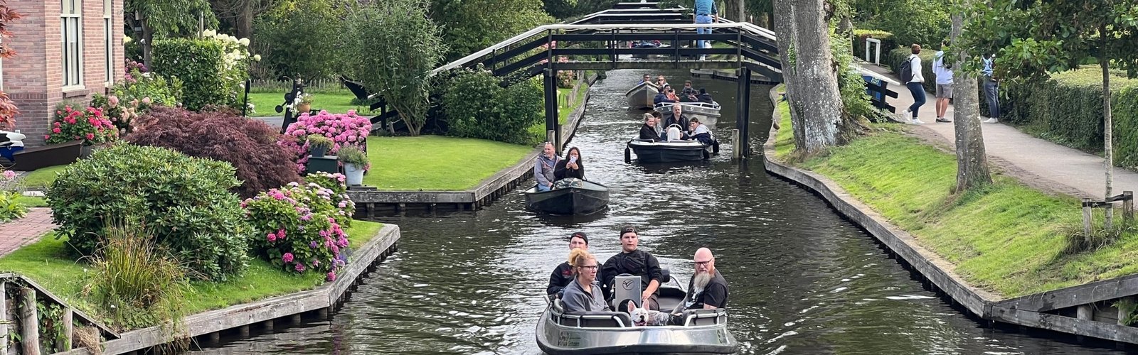 Visitors relish a scenic boat ride along the central canals of Giethoorn.