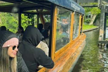 Lady in pink hat on a boat in Giethoorn canal.