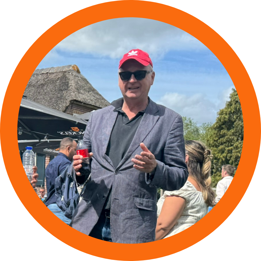 Igor the tour guide with red cap and drink outdoors