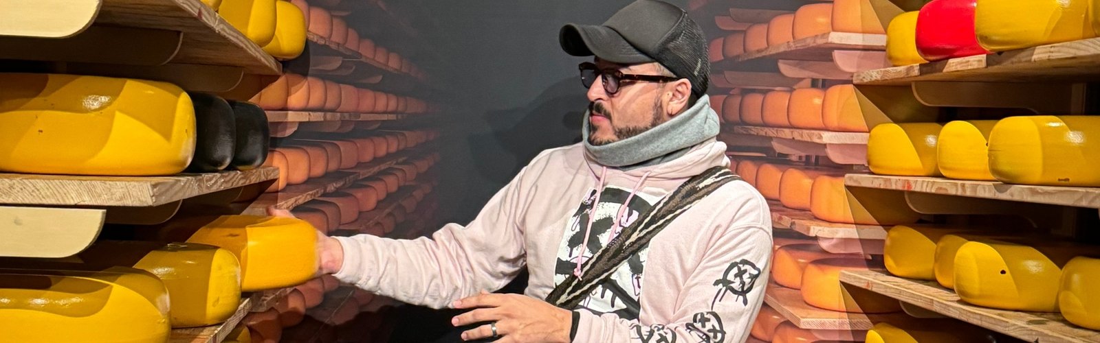 Person exploring cheese in storage room shelves